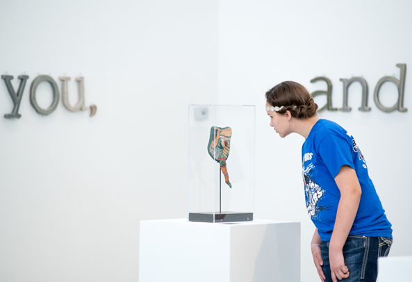 Student Looking at an Exhibited Artwork
