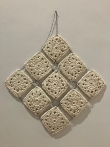 Olivia Hawk, "Beyond Function", 2023; slip cast soaked granny squares, glaze, jump rings; Courtesy of the artist