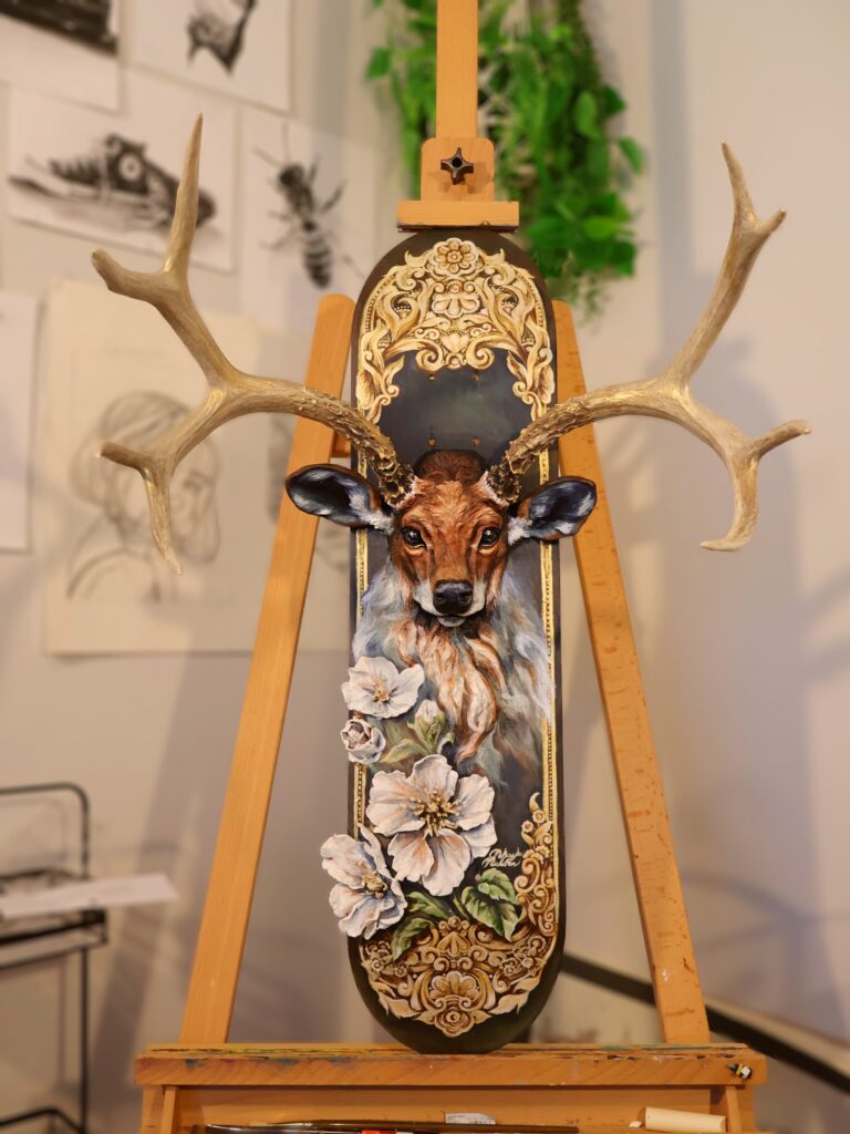 Nikayla Nielson, "Emergence", 2025; Mixed media: Blank skateboard desk, donated deer antlers, air-dry clay, acrylic paint, archival adhesives, varnish; Courtesy of the artist.