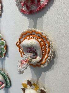 Amy Meissner, "Milk on the Tongue", 2022; Vintage crocheted potholders, embroideries, abandoned crazy quilts, glass and plastic craft beads, swarovski crystals; Museum purchase.